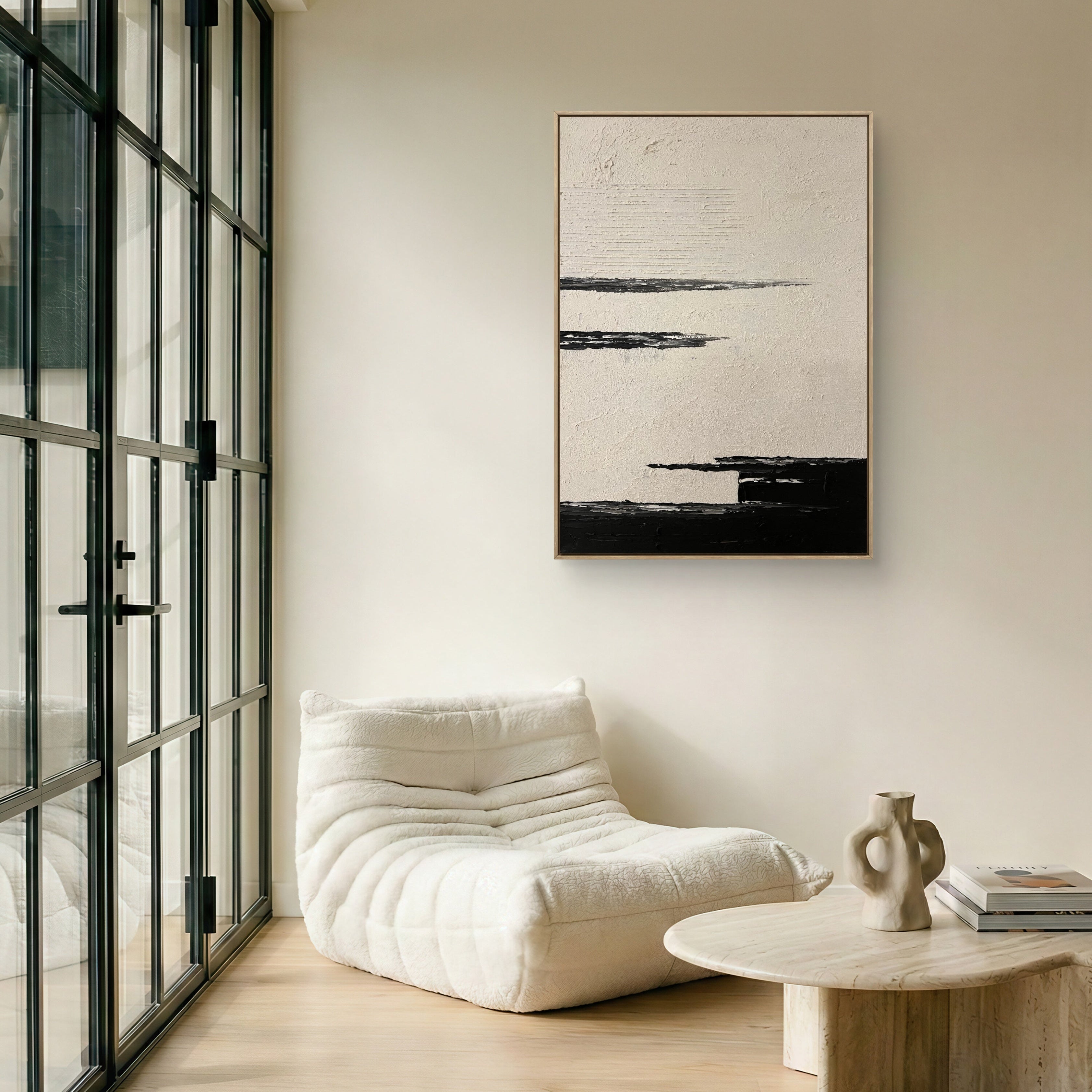 Modern living room with a white armchair, wooden coffee table, and abstract art on the wall.
